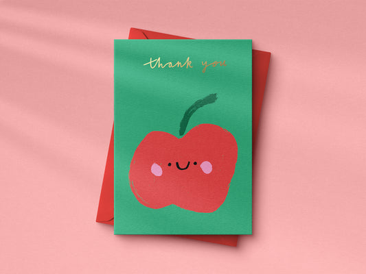 Green card with a red apple illustration and 'thank you' text on a pink background